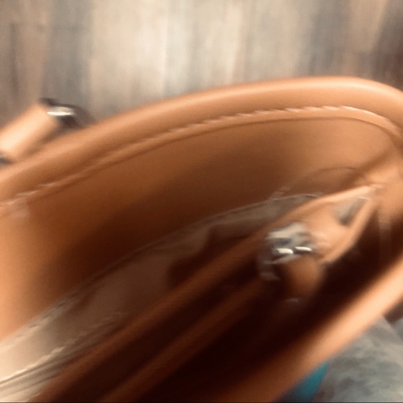 The turquoise bag has tan braided accent.  3 sections to hold your items. - Picture 2 of 5